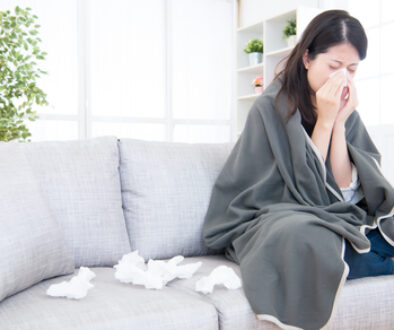 Sick Young Woman Sneeze At Home