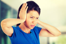 Young woman with huge head ache