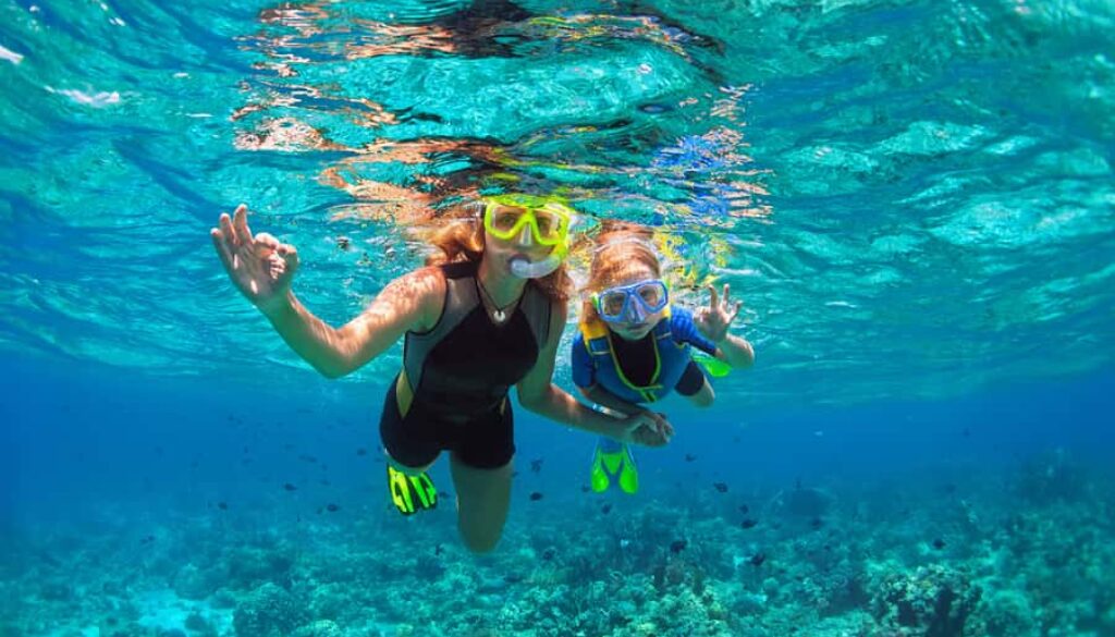 snorkeling mother and child