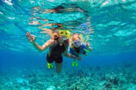 snorkeling mother and child