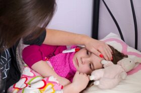 Mother taking care about sick sleeping daughter
