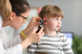 A Female Ent Doctor Examining a Child’s Ear With an Otoscope Ear Infections in Children