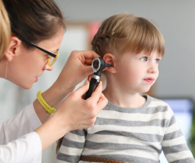 A Female Ent Doctor Examining a Child’s Ear With an Otoscope Ear Infections in Children