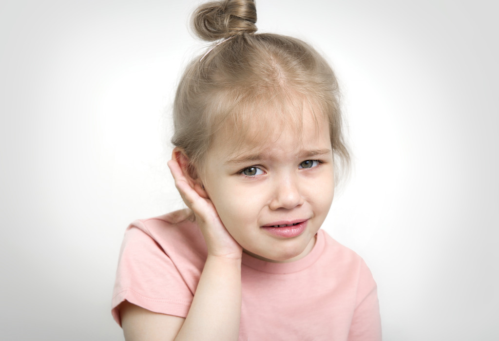 A Toddler With an Ear Infection Holding Her Ear