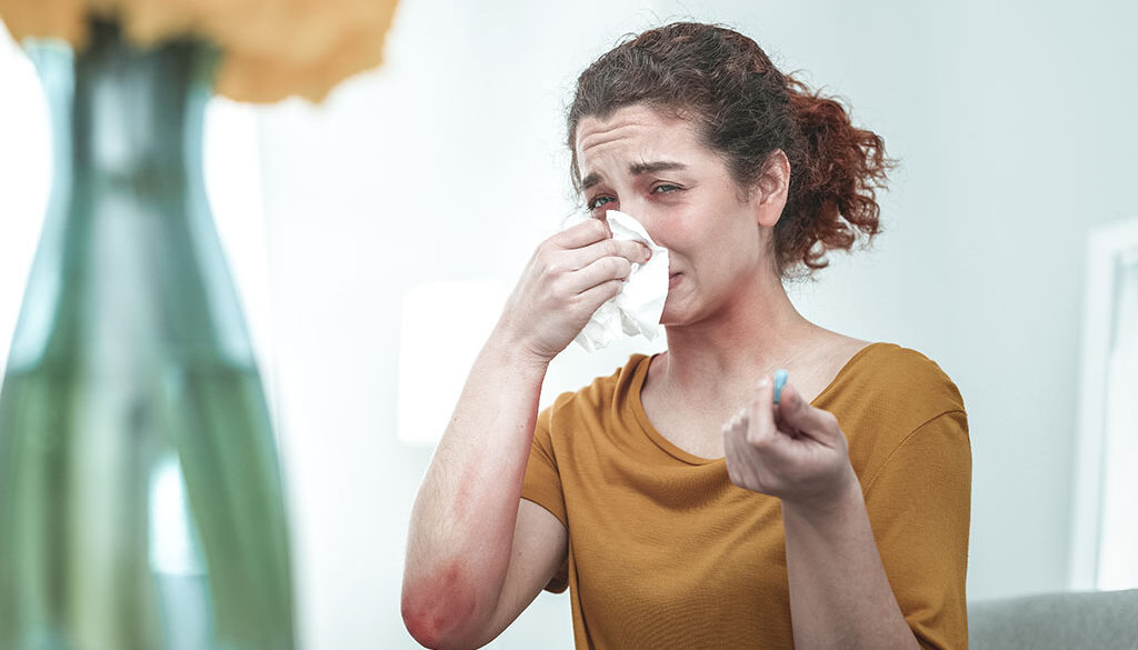 A Woman Blowing Her Nose Suffering From a Dry Nose How to Fix Nasal Dryness